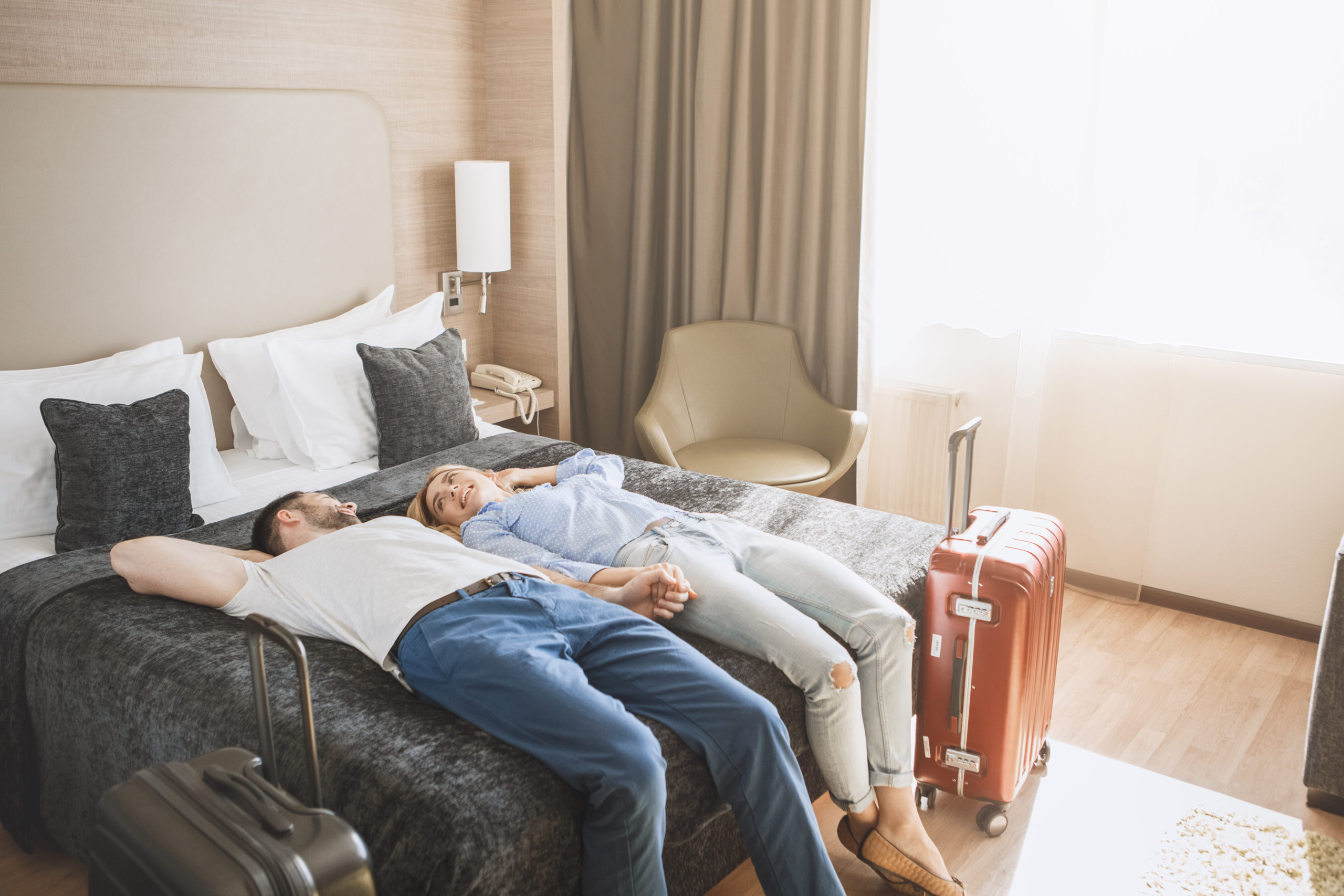 commercial-and-hospitality-Design-by-MDfxcouple-relaxing-on-bed-in-hotel-bedroom-with-air-purification-system-