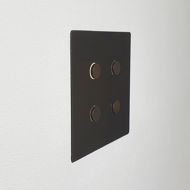 Black Alisse Lutron Keypad flush mounted onto plastered wall.